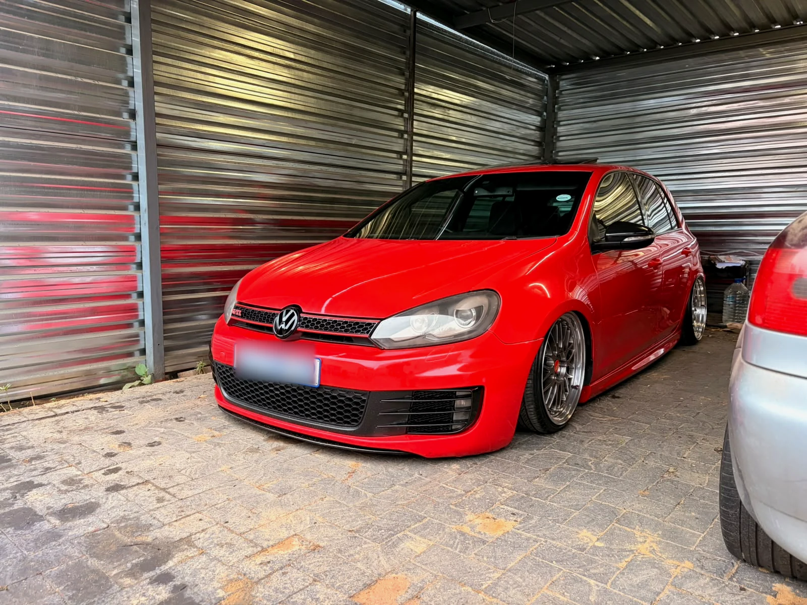 Modified red Volkswagen Golf photographed from the front three-quarter angle